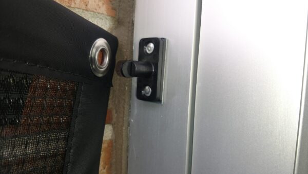 Close-up of MagnaMount magnetic fastener securing a mesh filter panel to metal surface