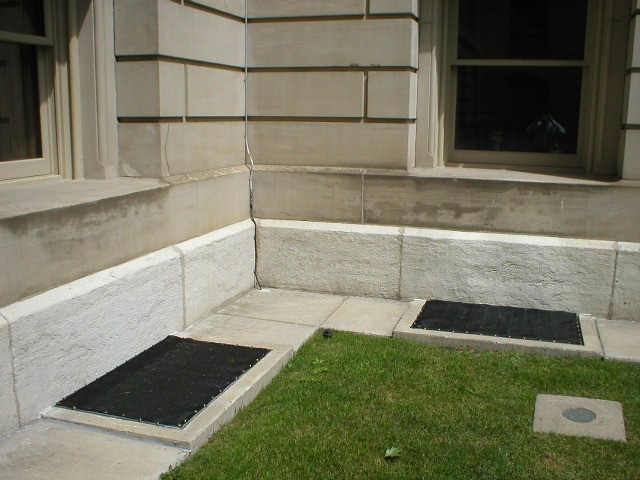Ground-level intake louvers protected with PreVent air filter screens on exterior building wall